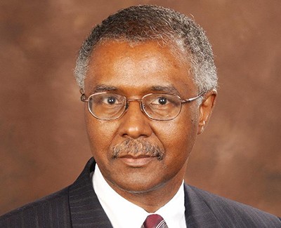 Jerome Davis, wearing a suit and glasses