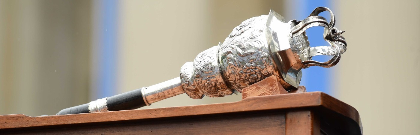 Silver crowned Columbia scepter lies atop a wooden podium