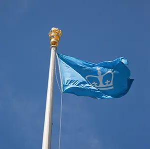 The Columbia University flag flaps gently in the wind.